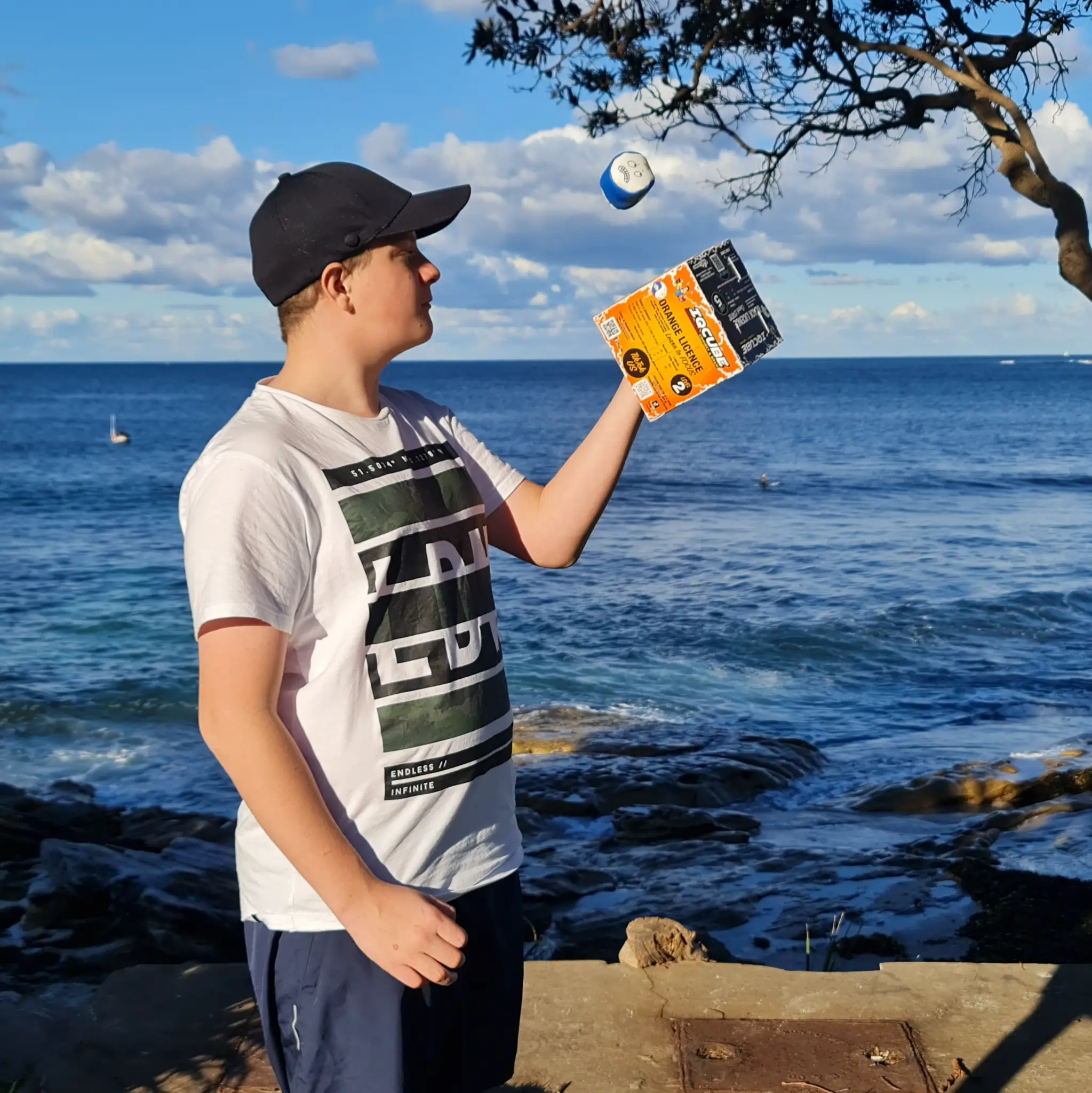 Young person playing Thingy Flip beside the ocean